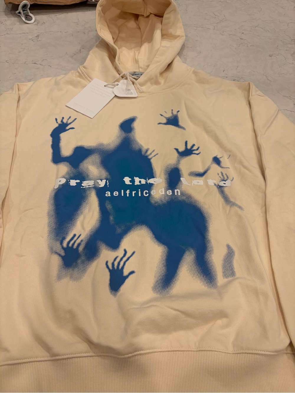 Aelfric Eden Cream Hoodie with Blue Spray Graphic